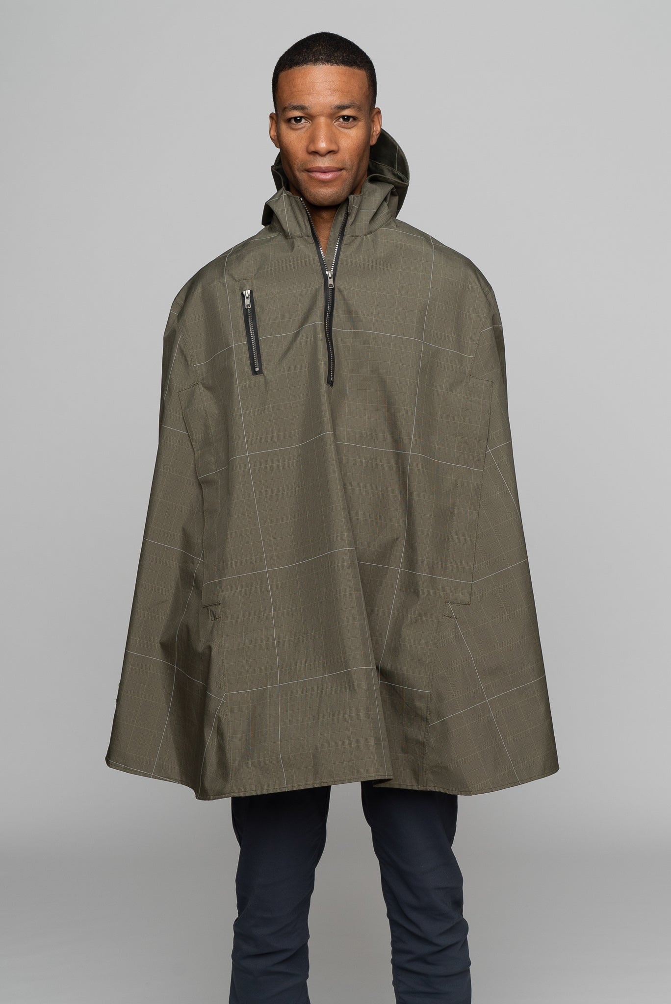 Great for walking or riding travels and commutes. Made of sustainable, recycled polyester. Navy and white check with interwoven reflective thread creates a bright hi-vis grid that stands out on rainy days and nights. Elastic thumb loops keep the poncho secure when riding. Fully seam-sealed, and carefully crafted. 