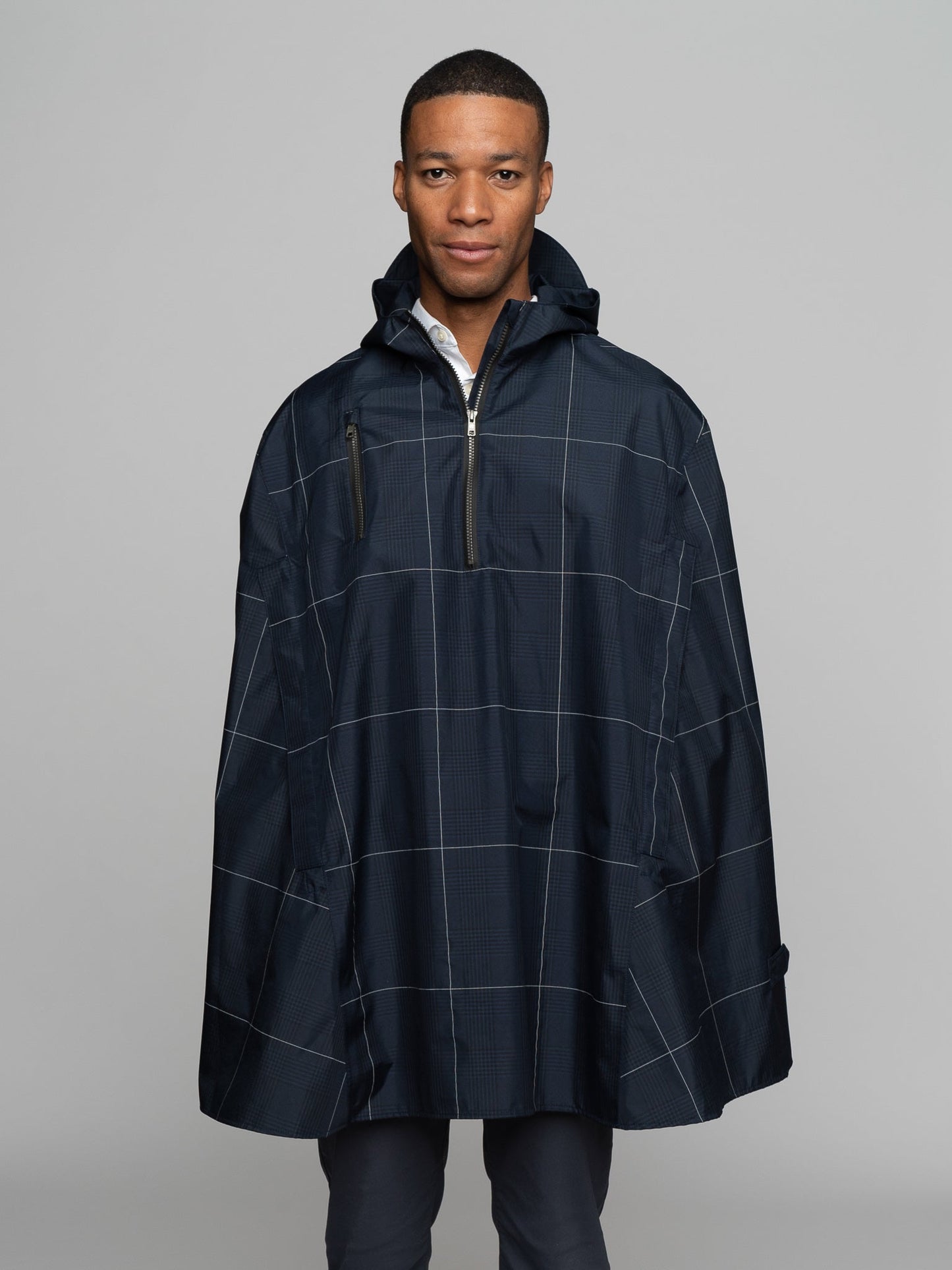 Great for walking or riding travels and commutes. Made of sustainable, recycled polyester. Navy and white check with interwoven reflective thread creates a bright hi-vis grid that stands out on rainy days and nights. Elastic thumb loops keep the poncho secure when riding. Fully seam-sealed, and carefully crafted.