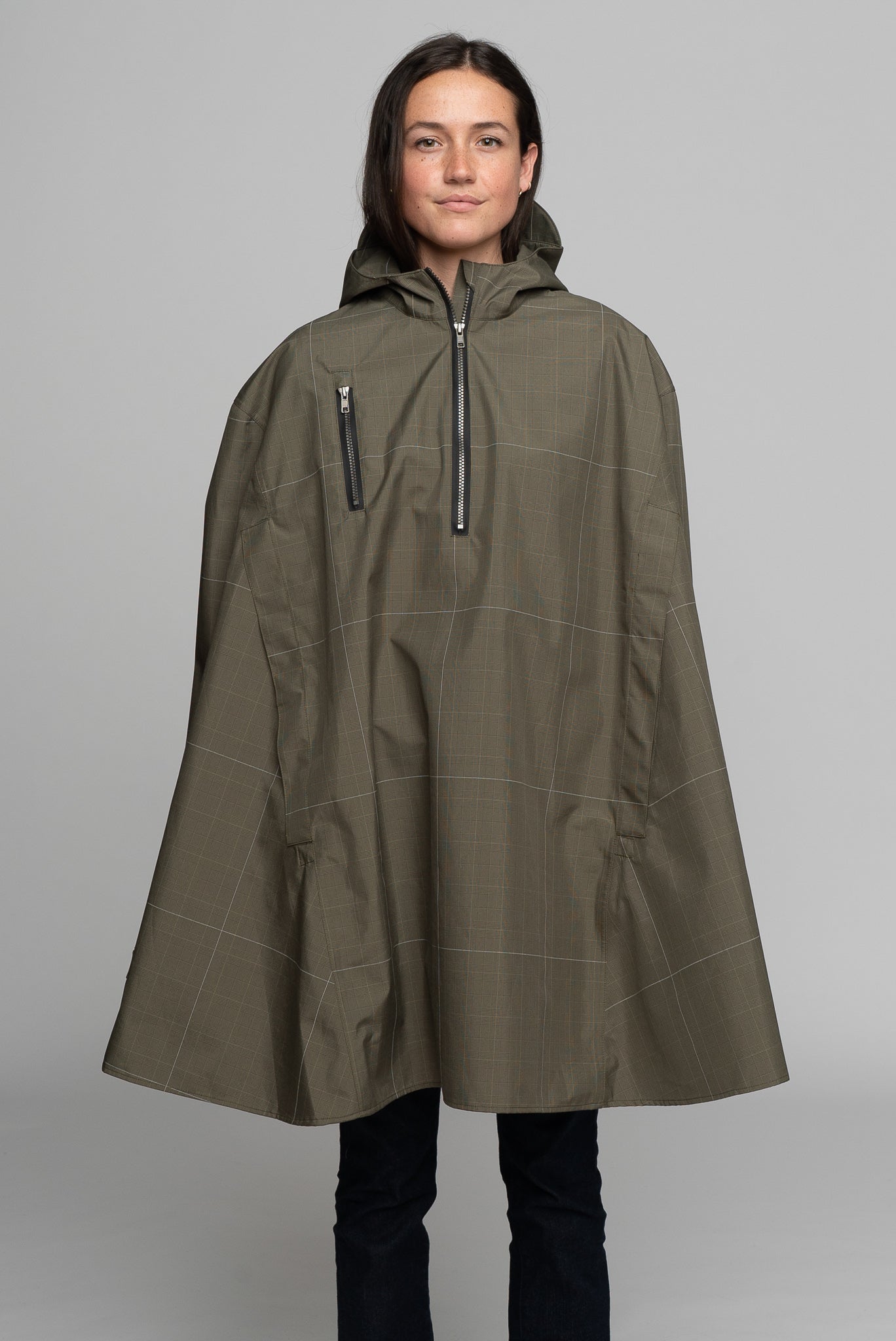 Great for walking or riding travels and commutes. Made of sustainable, recycled polyester. Navy and white check with interwoven reflective thread creates a bright hi-vis grid that stands out on rainy days and nights. Elastic thumb loops keep the poncho secure when riding. Fully seam-sealed, and carefully crafted.